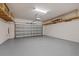 Spacious two-car garage with epoxy floor, ample lighting, and storage shelving at 834 N Oregon Ave, Tampa, FL 33606