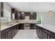 Well-appointed kitchen with dark cabinetry, sleek countertops, and mosaic tile backsplash at 834 N Oregon Ave, Tampa, FL 33606
