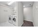 Bright laundry room features a modern washer and dryer, shelving, and stylish tile flooring at 834 N Oregon Ave, Tampa, FL 33606