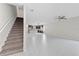 Open-concept living space with a staircase leading upstairs, seamlessly connected to the modern kitchen at 834 N Oregon Ave, Tampa, FL 33606