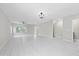 Spacious living room featuring tile floors, modern ceiling fan, and abundant natural light at 834 N Oregon Ave, Tampa, FL 33606