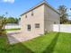 View of the home's backyard with a brick patio and white fence, perfect for outdoor entertaining at 8806 Bayaud Dr, Tampa, FL 33626