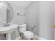 Clean and modern bathroom featuring a pedestal sink, toilet, and towel rack, creating a functional space at 8806 Bayaud Dr, Tampa, FL 33626
