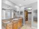 Bathroom featuring vanity with stone countertop, mirror, and open access to a walk-in closet at 8806 Bayaud Dr, Tampa, FL 33626