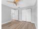 Bedroom with laminate floors offers closet and connects to another room at 8806 Bayaud Dr, Tampa, FL 33626