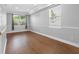 Bright bedroom with hardwood floors, large windows, and ample natural light creates a serene atmosphere at 8806 Bayaud Dr, Tampa, FL 33626