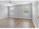 Spacious bedroom with laminate floors and ample natural light from two windows at 8806 Bayaud Dr, Tampa, FL 33626