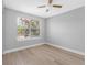 Light-filled bedroom with laminate flooring and natural light from window at 8806 Bayaud Dr, Tampa, FL 33626