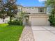 Charming two-story home with a well-manicured lawn and inviting walkway leading to the front door at 8806 Bayaud Dr, Tampa, FL 33626