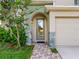 Close-up of the front door entrance with decorative stone accents and well-maintained landscaping at 8806 Bayaud Dr, Tampa, FL 33626