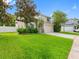 Spacious two-story home with an attached two car garage, stone accents, and a lush green lawn at 8806 Bayaud Dr, Tampa, FL 33626