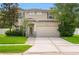 Well maintained two-story home with landscaped lawn, mature trees and an attached two-car garage at 8806 Bayaud Dr, Tampa, FL 33626