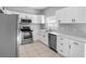 Modern kitchen featuring stainless steel appliances, white cabinets, and light countertops at 8806 Bayaud Dr, Tampa, FL 33626