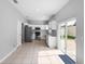 Spacious kitchen with tile flooring, white cabinets, stainless appliances, and sliding glass doors at 8806 Bayaud Dr, Tampa, FL 33626