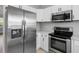 Well-equipped kitchen with stainless steel refrigerator, microwave, and electric range at 8806 Bayaud Dr, Tampa, FL 33626