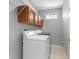 Functional laundry room with washer, dryer, and storage cabinets at 8806 Bayaud Dr, Tampa, FL 33626