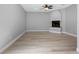 Inviting living room featuring hardwood floors and a classic fireplace at 8806 Bayaud Dr, Tampa, FL 33626
