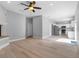 Open-concept living room with hardwood floors connecting to the kitchen at 8806 Bayaud Dr, Tampa, FL 33626