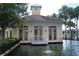 View of the community clubhouse with a tower and decorative pond at 9320 Crescent Loop Cir # 304, Tampa, FL 33619