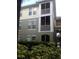 Three-story condo with two screened balconies and manicured shrubbery at 9320 Crescent Loop Cir # 304, Tampa, FL 33619