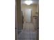 Galley kitchen with white tile floors and stainless appliances at 9320 Crescent Loop Cir # 304, Tampa, FL 33619