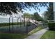 Fenced in community playground area with mature landscaping at 9320 Crescent Loop Cir # 304, Tampa, FL 33619
