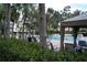 Community pool area surrounded by palms and lush tropical vegetation at 9320 Crescent Loop Cir # 304, Tampa, FL 33619