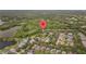 Wide aerial view showing a property surrounded by trees and neighboring houses, marked with a location pin at 9327 Hunters Park Way, Tampa, FL 33647
