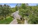 Aerial view of a well maintained yard and a beige one story home with an attached two car garage at 9327 Hunters Park Way, Tampa, FL 33647
