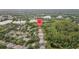Extensive aerial view of a residential area with ponds and trees, marked with a location pin at 9327 Hunters Park Way, Tampa, FL 33647