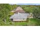 Overhead view of a well maintained and landscaped yard with screened in porch in a row of houses and many trees at 9327 Hunters Park Way, Tampa, FL 33647