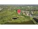 Scenic aerial view showing the home's location surrounded by lush greenery, ponds, and community, marked by a location pin at 9327 Hunters Park Way, Tampa, FL 33647