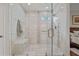 Beautiful glass enclosed shower with a built-in seat and neutral tiling at 9327 Hunters Park Way, Tampa, FL 33647