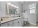 Well-lit bathroom featuring a large mirror, marble countertop, and updated fixtures at 9327 Hunters Park Way, Tampa, FL 33647