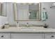 Bathroom sink with marble countertops, white cabinetry, and a decorative framed mirror at 9327 Hunters Park Way, Tampa, FL 33647