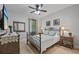 Comfortable bedroom featuring a decorative metal frame bed and neutral color scheme at 9327 Hunters Park Way, Tampa, FL 33647