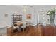 Bright dining room with hardwood floors, modern lighting, and decorative shelving unit at 9327 Hunters Park Way, Tampa, FL 33647