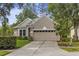 Charming one-story home with a two car garage and a well-manicured lawn at 9327 Hunters Park Way, Tampa, FL 33647