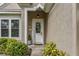 Charming front entrance boasting a decorative glass door, well-manicured shrubs, and a welcoming ambiance at 9327 Hunters Park Way, Tampa, FL 33647
