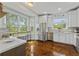 Beautiful kitchen with stainless steel appliances, white cabinetry, and ample counter space with large windows at 9327 Hunters Park Way, Tampa, FL 33647
