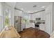 Modern kitchen featuring stainless steel appliances, white cabinets, and hardwood floors with lots of windows at 9327 Hunters Park Way, Tampa, FL 33647