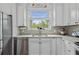 Well-appointed kitchen with stainless steel appliances, crisp white cabinets, and stylish countertops at 9327 Hunters Park Way, Tampa, FL 33647