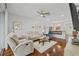 Spacious living room with hardwood floors, ceiling fan, and comfortable seating at 9327 Hunters Park Way, Tampa, FL 33647
