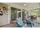 Covered patio featuring tile flooring, ceiling fans, comfortable seating, and sliding glass doors to the interior of the home at 9327 Hunters Park Way, Tampa, FL 33647