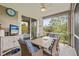 Relaxing screened patio with dining table, seating, and scenic outdoor views at 9327 Hunters Park Way, Tampa, FL 33647