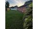 Spacious backyard with lush green grass and a privacy fence, perfect for outdoor activities at 9907 Maggie St, Gibsonton, FL 33534