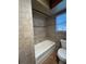 Tiled bathroom with classic fixtures, shower and bathtub at 9907 Maggie St, Gibsonton, FL 33534