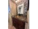 Remodeled bathroom with mosaic mirror, copper sink, and modern vanity at 9907 Maggie St, Gibsonton, FL 33534