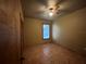 Bedroom featuring tile floors, a window with blinds, and a ceiling fan with lights at 9907 Maggie St, Gibsonton, FL 33534