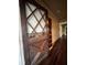 The entryway of the home features a beautiful diamond pane door and hardwood floors at 9907 Maggie St, Gibsonton, FL 33534